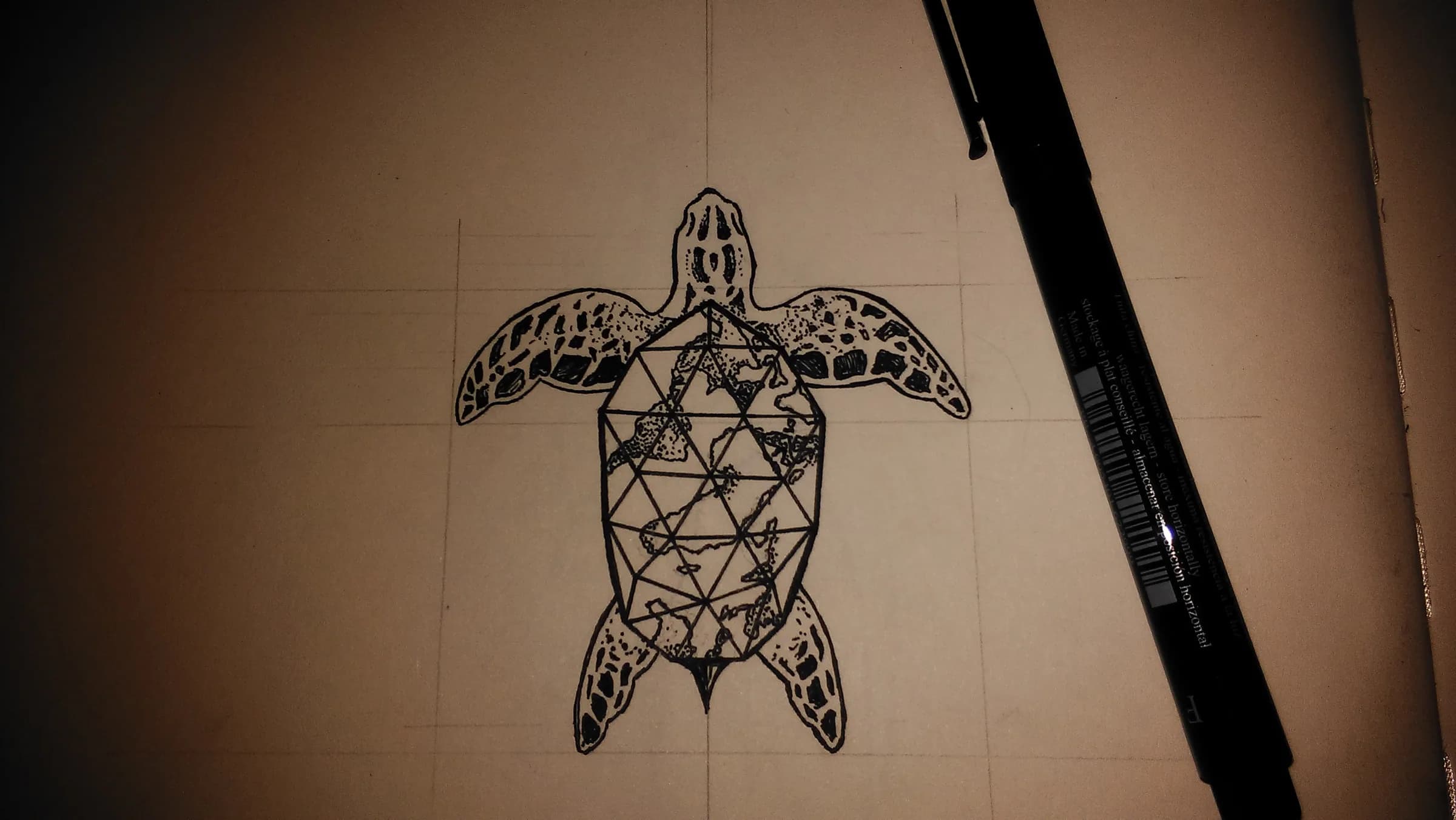 Geometric turtle drawn on a wall in warm light