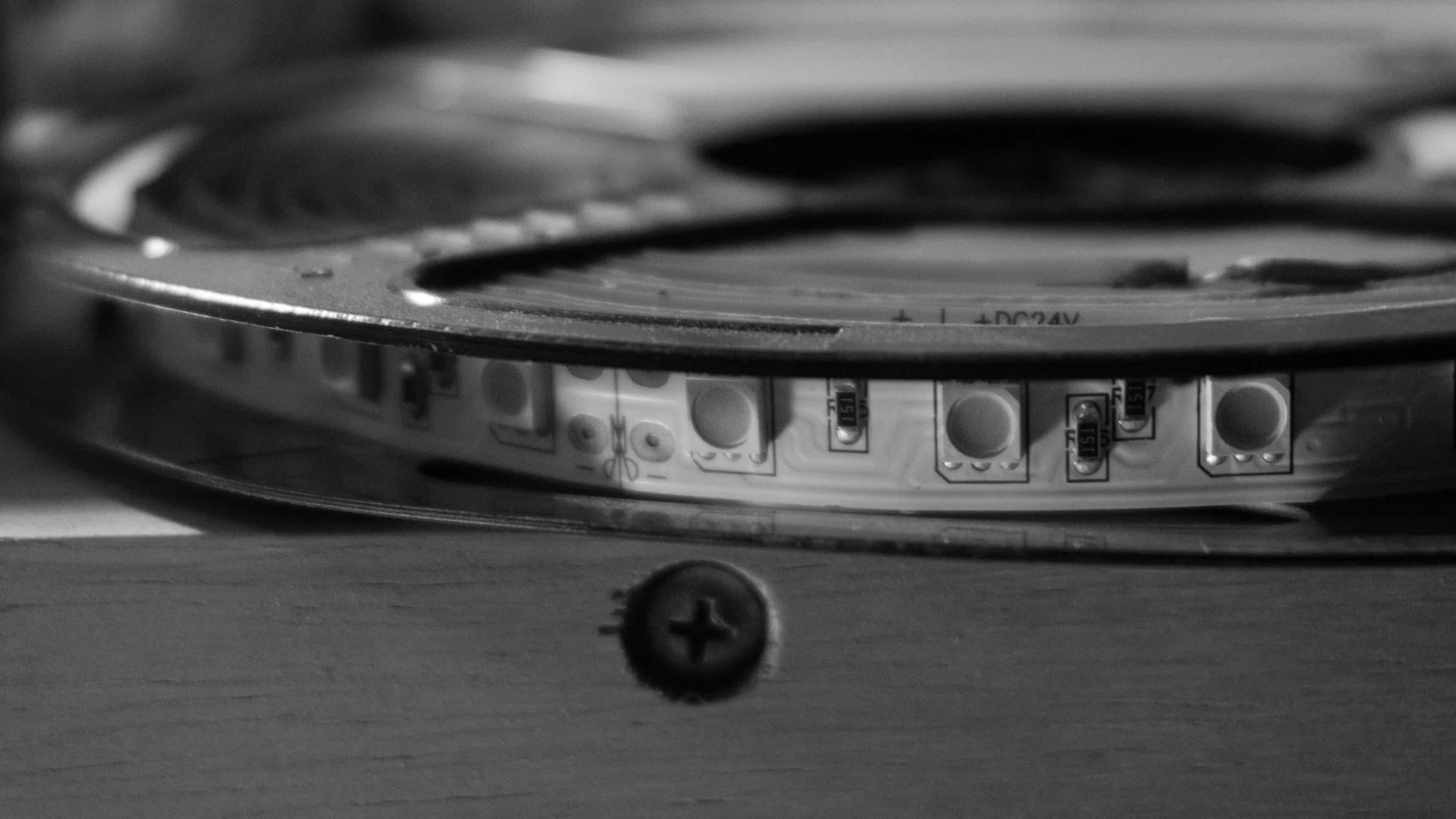Black-and-white macro of an LED ring and a screw